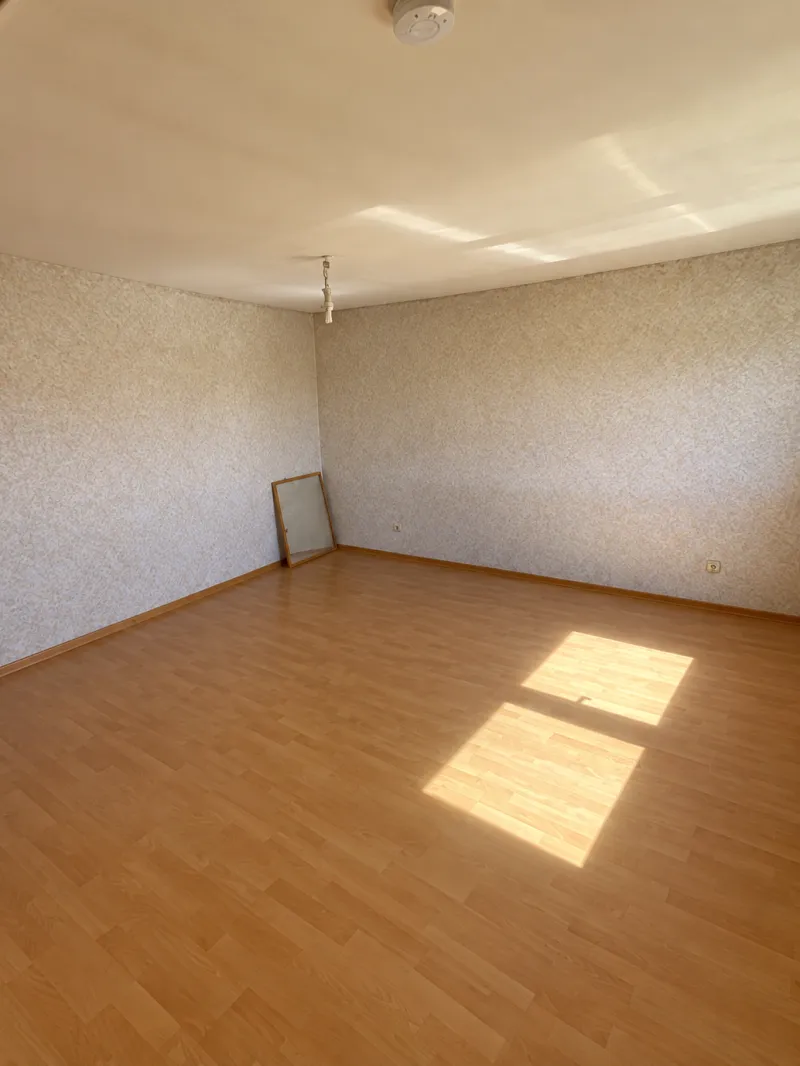 The same bedroom empty after the furniture was removed