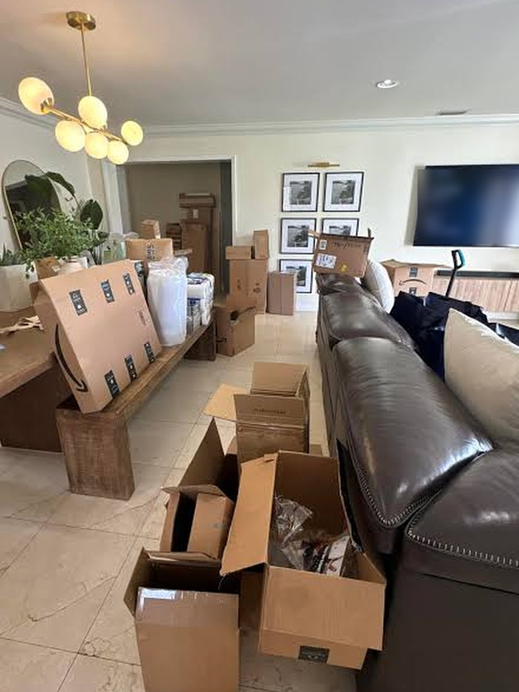 Living and dining area full of moving and shipping boxes